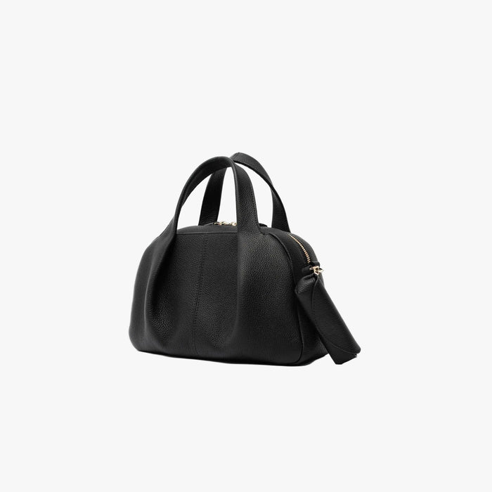 STOW London's Lipstick Case in Black pebbled leather attached to the Black Mini Bowling featuring a gold-coated stainless steel clip and embossed logo on a light grey background