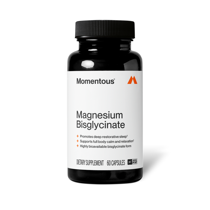 Front view of a Momentous Magnesium Bisglycinate supplement bottle. Black opaque bottle with black cap and white label featuring the Momentous logo and orange triangular "M" icon. Label reads: 'Magnesium Bisglycinate' with three benefit callouts — promotes deep restorative sleep, supports full body calm and relaxation, and highly bioavailable bisglycinate form. Bottom of label indicates: Dietary Supplement, 60 Capsules, and NSF Certified for Sport seal.