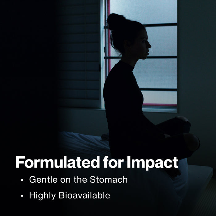 A woman sits on a bed with her legs drawn up in a dark room, silhouetted in profile against a window with blinds. Text reads: Formulated for Impact. Gentle on the Stomach. Highly Bioavailable.