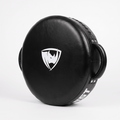 PROLAST round punch shield in black, standing on edge with the white rhino shield logo on the striking face