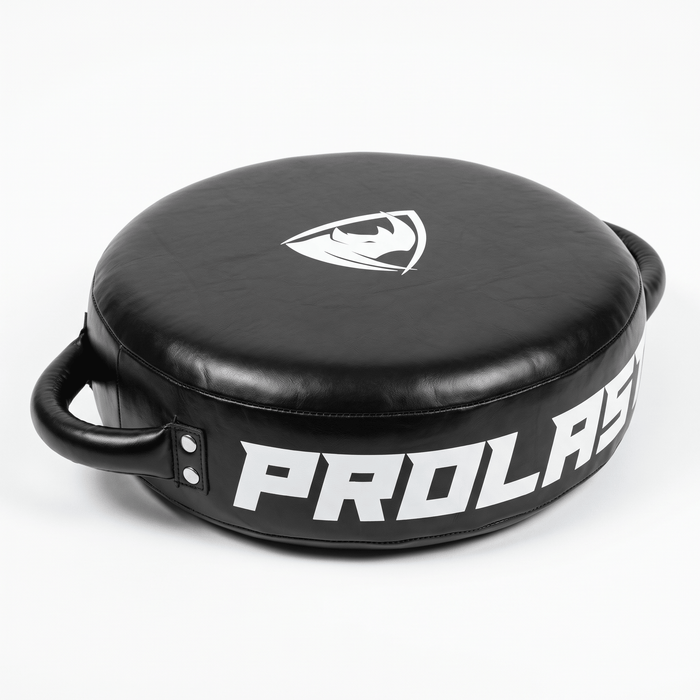 PROLAST round punch shield in black, angled top view with two side handles and PROLAST lettering on the rim
